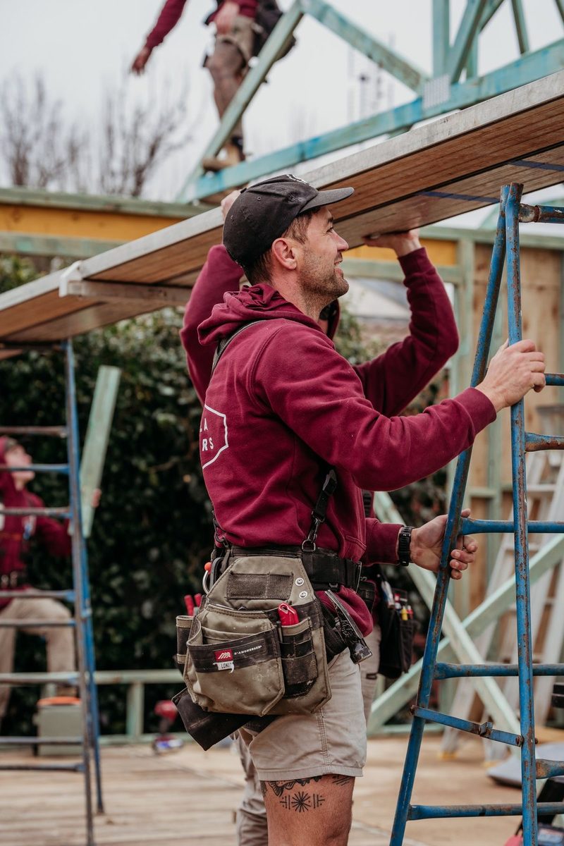 Australian builder installing timber roof framing on site