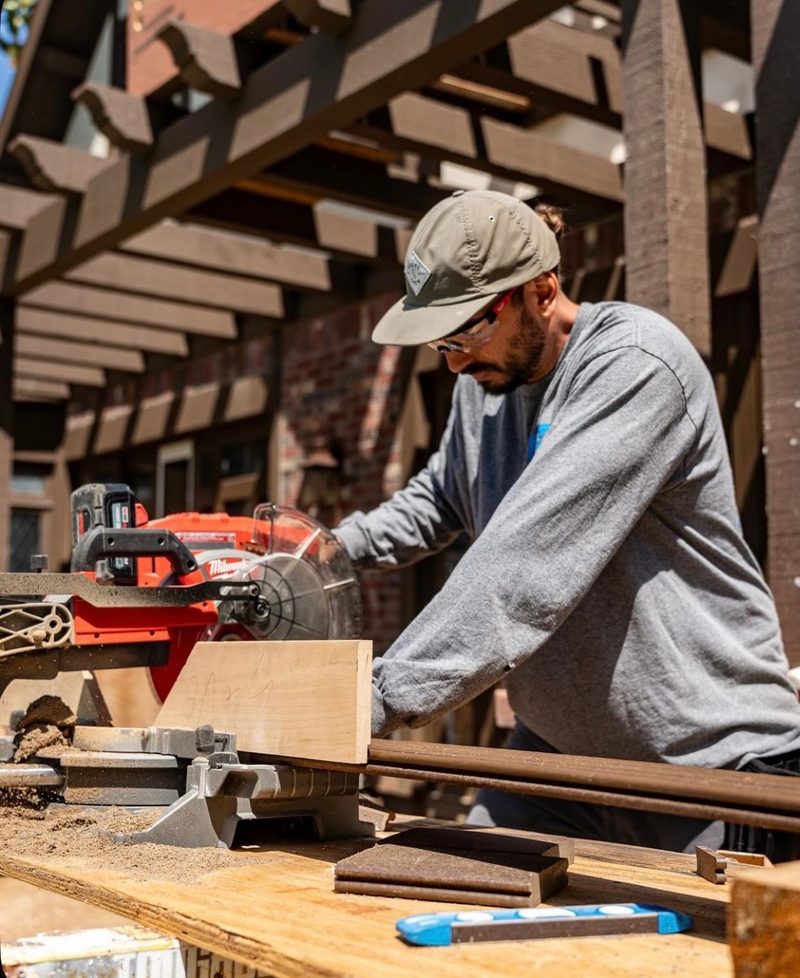 Australian carpenter cutting timber with a drop saw